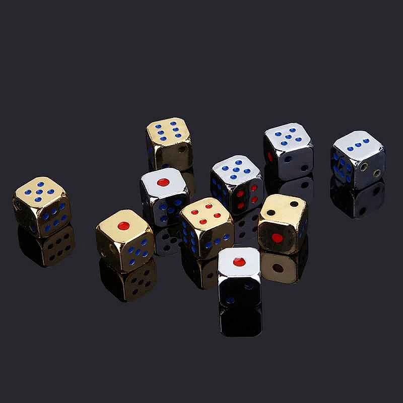 Close-up of metal dice showing colorful number inlays and polished finish
