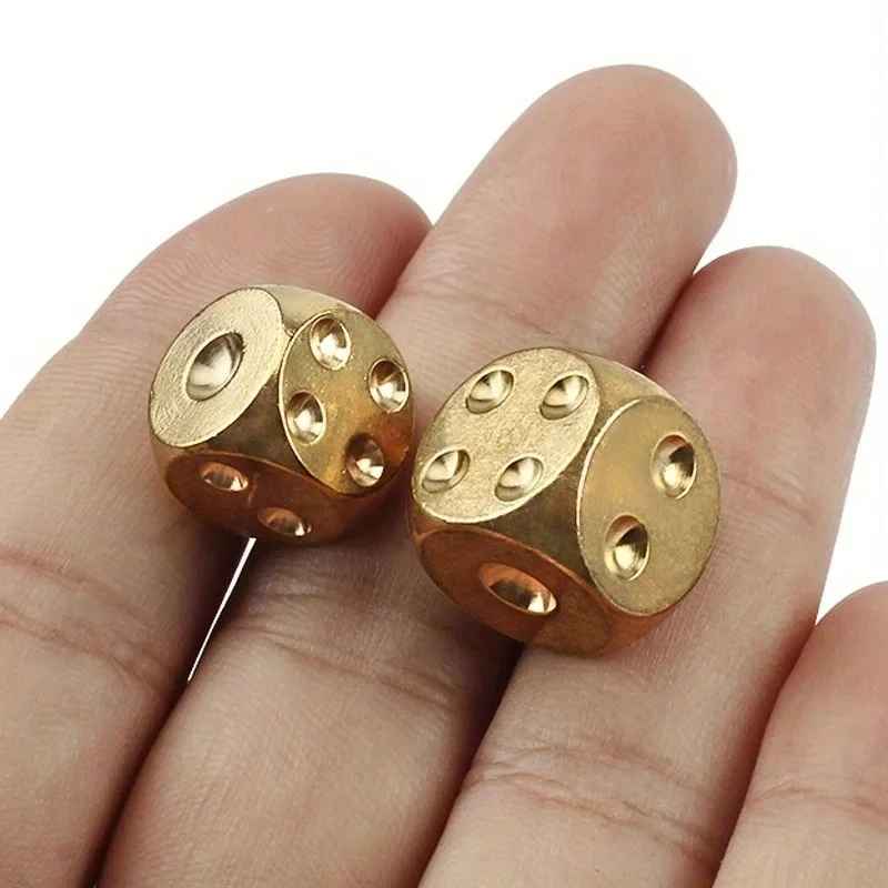 Close-up of brass dice showing texture detail and face numerals