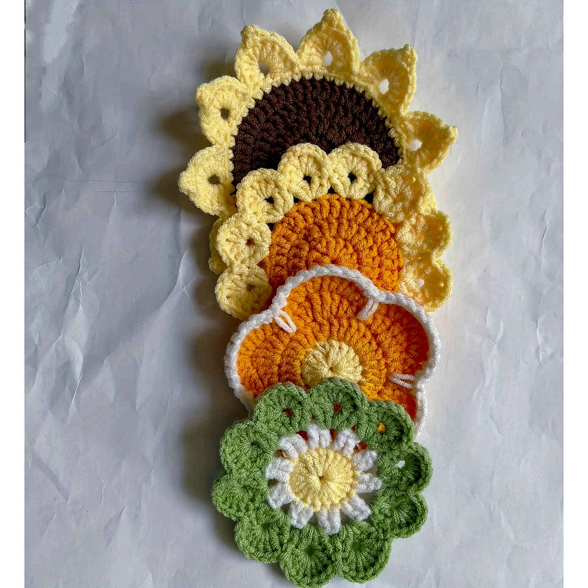 Handmade crochet sunflower coaster in yellow and brown tones, textured floral detail, protecting surface from mugs | BigMoets