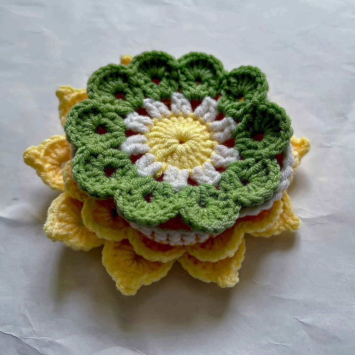 Handmade crochet sunflower coaster in yellow and brown tones, textured detail close-up, protecting surfaces | BigMoetsy