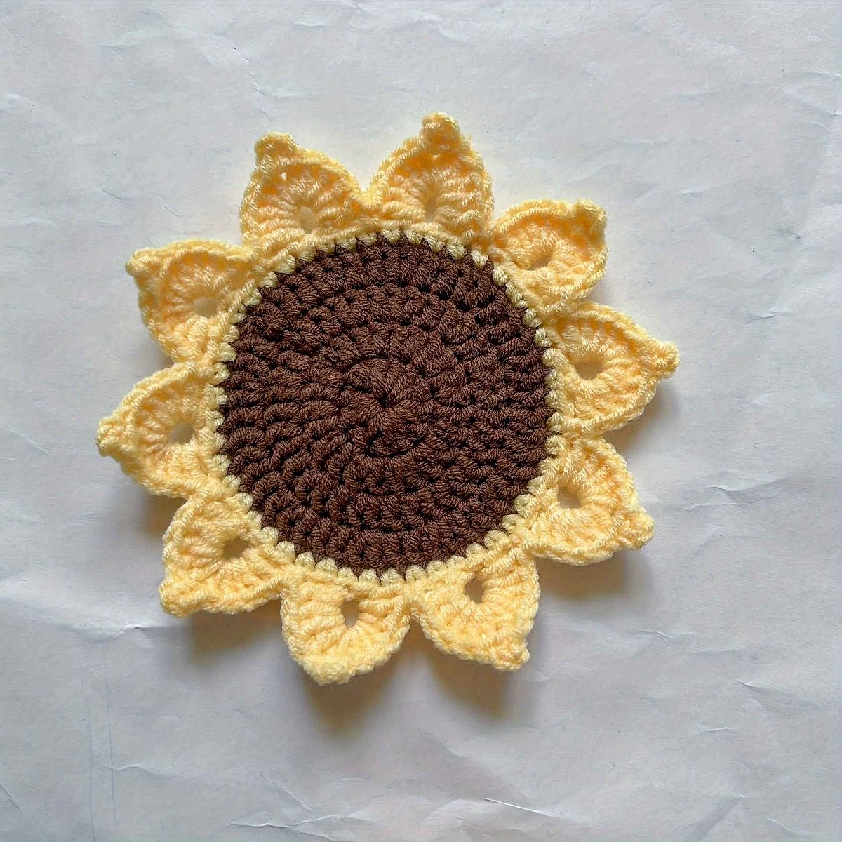 Handmade crochet sunflower coaster in yellow and brown tones, close-up detail view showing texture and craftsmanship | BigMoe